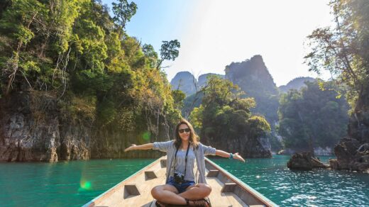 Photo of Woman Sitting on Boat Spreading Her Arms